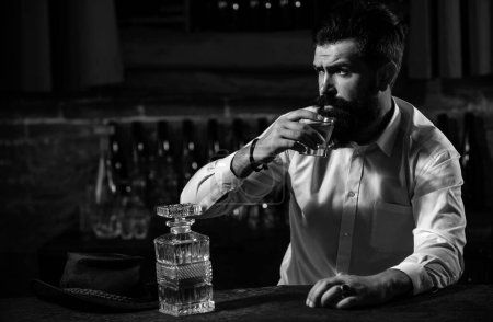Téléchargez les photos : Vie nocturne de luxe, riche homme barbu boisson chère - en image libre de droit