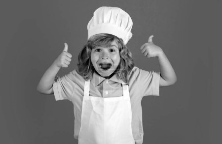 Photo for Excited funny chef cook. Child chef dressed cook baker apron and chef hat with thumbs up isolated on studio background. - Royalty Free Image