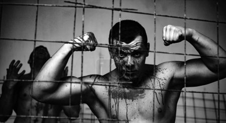 Photo for Strong aggressive monster behind grid. Prison for monster. Psycho mad man. Murderer mythical creature. Muscular man nude torso soiled blood. Halloween concept. Scary monster just murdered his victim. - Royalty Free Image