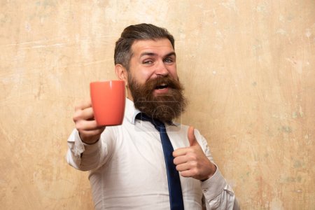 Photo for Happy morning. Man holds cup of coffee. Morning tea. Good morning. Man with tea cup. Hipster man with cup of coffee. Bearded man smiling hold mug tea. Wake up. Happy day. After morning tea - Royalty Free Image