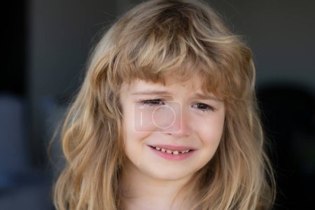 Photo for Close up kid crying with tearful on face. Kid crying with a tear on cheek - Royalty Free Image