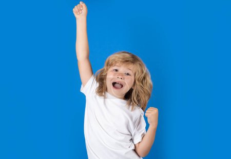Photo for Excited child celebrating victory on studio isolated background. Surprised face, amazed emotions of child. Rejoicing, yes gesture and success concept - Royalty Free Image