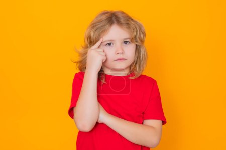 Photo for Kid boy have idea on yellow isolated background. Child pointing up finger. Shocked kid pointing up, thinking - Royalty Free Image