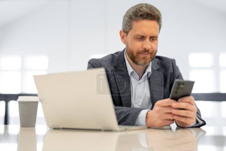Photo for Business man working in office. Businessman in casual suit using laptop in office. Business man office worker in formal suit. Office manager talk phone. Ceo businessman using smartphone - Royalty Free Image