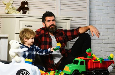 Photo for Father and son create toys from bricks. Cute little kid son play toy cars with dad, happy family son and loving young father babysitter having funon floor at home. Dad and kid build of plastic blocks - Royalty Free Image