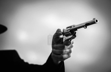 Photo for Close up shooter hand with guns, vintage pistol revolver. Wild west with cowboy - Royalty Free Image