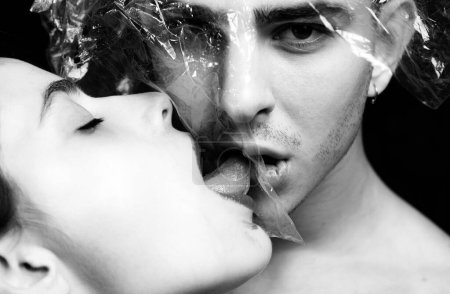 Photo for Oral condom concept. Protecting health. Health protection. Sexually transmitted diseases. Sexual activity. Sex health. Couple kissing through transparent plastic. Girl sexy tongue lick guy. Safe sex. - Royalty Free Image