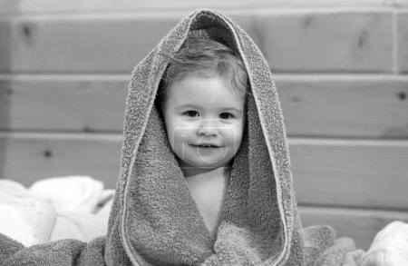 Photo for Kids baby cover head under towel after bath, portrait, close up head of cute child - Royalty Free Image
