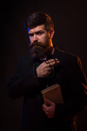 Photo for Pastor with a Bible in his hand during a sermon. Pastor or preacher praying, priest portrait of male pastor - Royalty Free Image