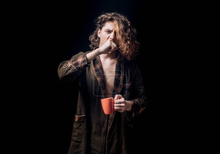 Photo for Mans holds cup of coffee and yawning. Morning tea. Yawning face. Man with tea cup. Hipster man yawning with cup of coffee. Bearded man yawning hold mug tea. Wake up. Happy day. After morning tea - Royalty Free Image