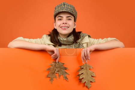Photo for Autumn woman, isolated portrait. Young model with autumn fall leaves in isolated studio background - Royalty Free Image