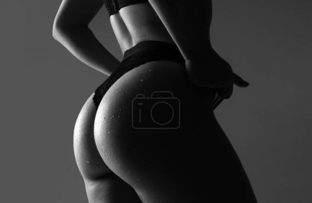 Photo for Huge buttocks. Sexy ass in erotic lingerie. Woman sexy silhouette body in panties. Butt with sensual touch - Royalty Free Image