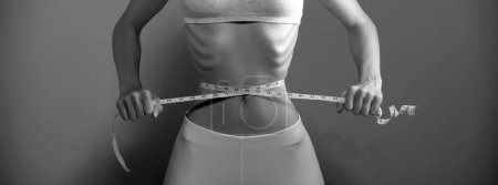 Photo for Weight loss, waist measurement, diet and health concept. Woman measuring her waist - Royalty Free Image