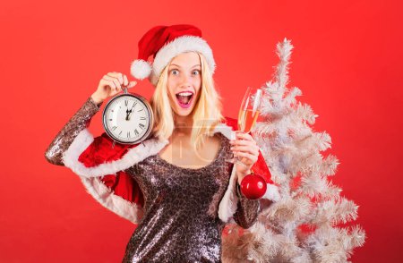 Photo for Cute young woman with santa hat. Funny girl in santa clause costume. Portrait of a young smiling woman. Funny Laughing Surprised Woman Portrait. Event - Royalty Free Image