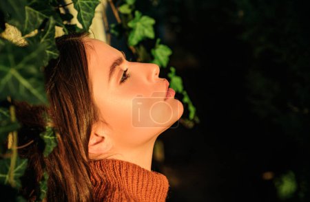 Photo for Profile portrait of beautiful model with natural make up and perfect smooth skin catching the last sunshine light. Autumn queen. Close up portrait of sexy brunette woman - Royalty Free Image