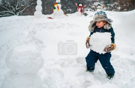 Photo for Cute kid - winter portrait. Winter scene with happy child on white snow background. Winter portrait of cute child in snow Garden - Royalty Free Image
