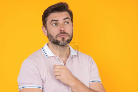Photo for Portrait of thoughtful guy making choice. Handsome man thinking on isolated studio background. Man thinking and doubting. Concerned mature man frowning. Dreamy cheerful expression, thinking - Royalty Free Image