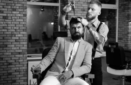 Photo for Razor blade. Barber - Shaves and Trims. Hairdressers work for a handsome guy at the barber shop. Hair Preparation is just for the dashing chap. Bearded client visiting barber shop - Royalty Free Image