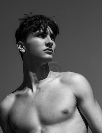 Photo for Handsome shirtless young man on lue sky background - Royalty Free Image