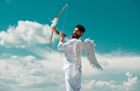 Photo for Surprised cupid with wings aiming with bow and arrow on a sky background. Funny valentines day concept. Humor comical concept - Royalty Free Image