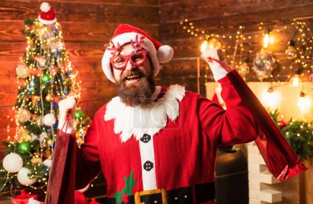 Photo for Crazy, funny Hipster Santa. Santa wishes merry Christmas and Happy new year. Holly jolly swag Christmas and noel - Royalty Free Image