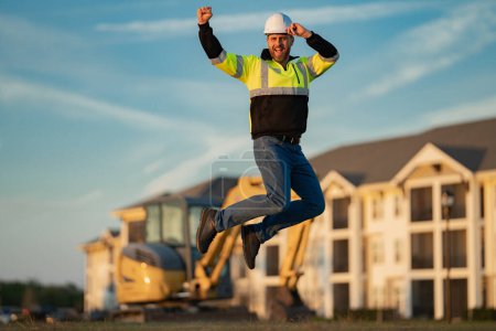 Photo for Worker in helmet on site construction. Excavator bulldozer male worker. Construction driver worker with excavator on the background. Construction worker with tractor or construction at building - Royalty Free Image