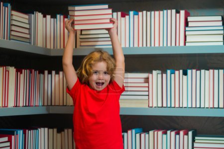 Photo for Excited school kid hold stack of books. Little student read book. School kid with pile of books. Children enjoying book story in school library. Kids imagination, interest to literature - Royalty Free Image