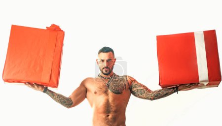 Photo for Birthday or valentine present. Sexy muscular man holding Christmas gifts. Santa has surprise. Naked man with sexy naked body holding a present isolated on white - Royalty Free Image