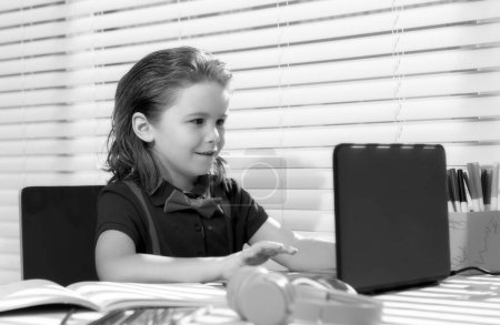 Photo for School boy pupil is studying online. Home schooling. Kids distance learning. Cute child using laptop. Education, online study, home studying, homework, schoolboy concept - Royalty Free Image