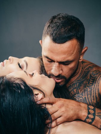 Photo for Passionate lover caressing arousing beautiful woman. Dominantning in the foreplay sexual game. Passionate woman with muscular latin lover. Dominant man. Night party - young lovers. Safety sex concept - Royalty Free Image