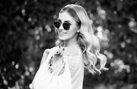 Photo for Beautiful young woman, tender girl in sunglasses. Fashion and beauty. Young woman on sunny summer day. Lifestyle, walk outdoors, enjoying life, positivity - Royalty Free Image
