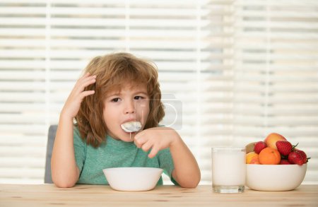 Photo for Child eat. Little healthy hungry boy eating soup from with spoon - Royalty Free Image