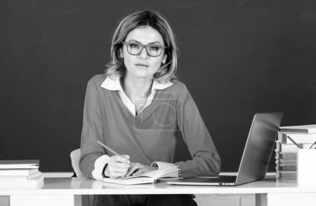 Photo for Education, high school and people concept Portrait of teacher or female tutor working at table in college or high school. Young women student studying in class - Royalty Free Image