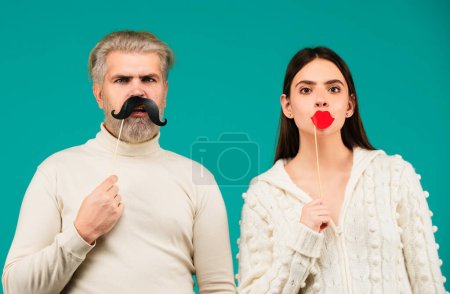 Photo for Party props. Happy couple having fun with with fake mustache and lips. Photo booth concept - Royalty Free Image