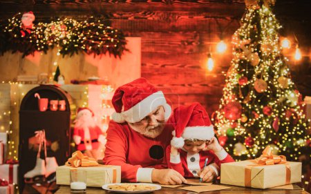 Photo for Cute little boy writing letter to Santa Claus at home. Wish List for Santa - Royalty Free Image