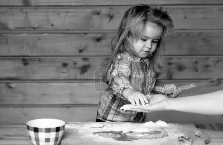 Photo for Childrens cook. Little child at kitchen cooking and playing with flour - Royalty Free Image