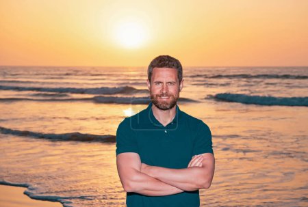 Photo for Man on the beach. Gorgeous stylish man wearing fashionable shirt. Beautiful and charming man posing outdoors. Summer sunset light - Royalty Free Image