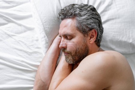 Photo for Man sleep in white bed. Sexy shirtless man sleep in bed at bedroom. Hispanic mature man sleeps at home at morning. Good sleep. Man sleeping in bed. People bedtime, rest sleep - Royalty Free Image