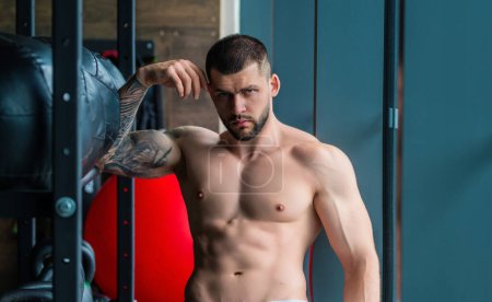 Photo for Sportsman muscular man workout in gym. Athletic man exercising with dumbbell. Fitness, sports concept, sport club, fitness center. Workout in gym. Sexy guy bodybuilder with perfect muscles body - Royalty Free Image