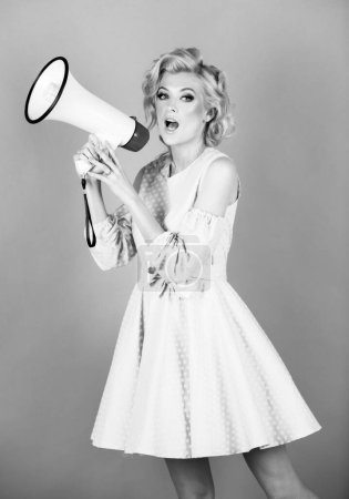 Photo for Shout girl speaks in a loudspeaker megaphone. Speaking loudly in the megaphone. Attractive woman with megaphone - Royalty Free Image