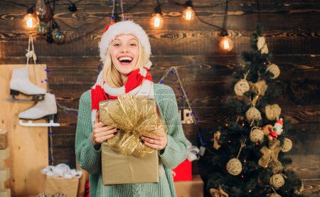 Photo for Cheerful young woman wearing christmas costume over wooden wall. Fashion portrait of girl indoors with Christmas tree. Woman smile christmas - Royalty Free Image