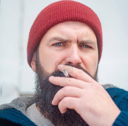 Photo for Cigarette nicotine addiction. Hipster brutal man smoking cigarette. Smoking addiction. Smoker gyu - Royalty Free Image