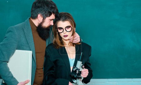 Photo for Sexy female student pointing at chalkboard. Workplace romance of handsome man and sexy woman in university. Friendship and good warm relations concept. Love romance seduction dating - Royalty Free Image
