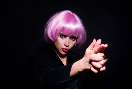 Photo for Shooting fingers. Womans hand making shooting gun, gesture. hand pistol gesture. Beautiful sexy woman in pink wig, isolated on black - Royalty Free Image