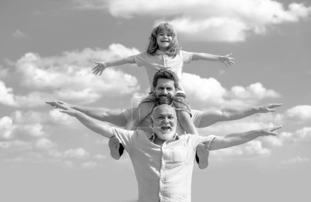 Photo for Fathers day. Father and son with grandfather raising hands or open arms flying. Men generation - Royalty Free Image