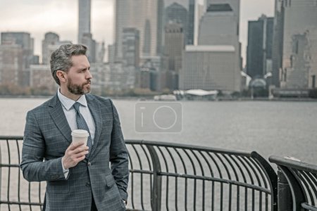 Photo for Business man on coffee break. Businessman at coffee break. Coffee break for business men. Businessman in business district in NYC. Coffee break in New York city. Business man hold take away drink - Royalty Free Image