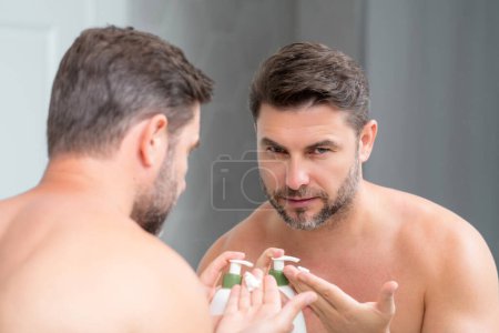 Photo for Sexy bearded man care of skin. Unshaven man with bristle and perfect skin. Male beauty and skincare concept. Man cosmetic, skin treatment. Morning hygiene. Mens cosmetics and spa and wellness - Royalty Free Image