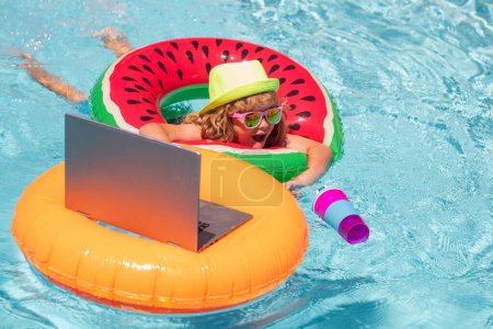 Photo for Business travel. Happy little boy learning online computer laptop. Kid relax on floating ring using computer in swimming pool. Summer business and technology - Royalty Free Image