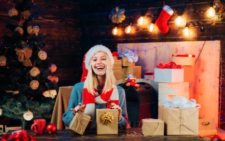 Photo for Christmas happy. Young woman with christmas present boxes in front of christmas tree. Celebration. Smiling girl winter. Christmas woman dress. December surprise and party time - Royalty Free Image