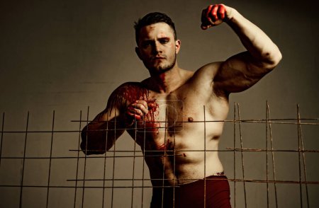 Photo for Prison for monster. Psycho mad man. Murderer mythical creature. Muscular man nude torso soiled blood. Halloween concept. Scary monster just murdered his victim. Strong aggressive monster behind grid. - Royalty Free Image